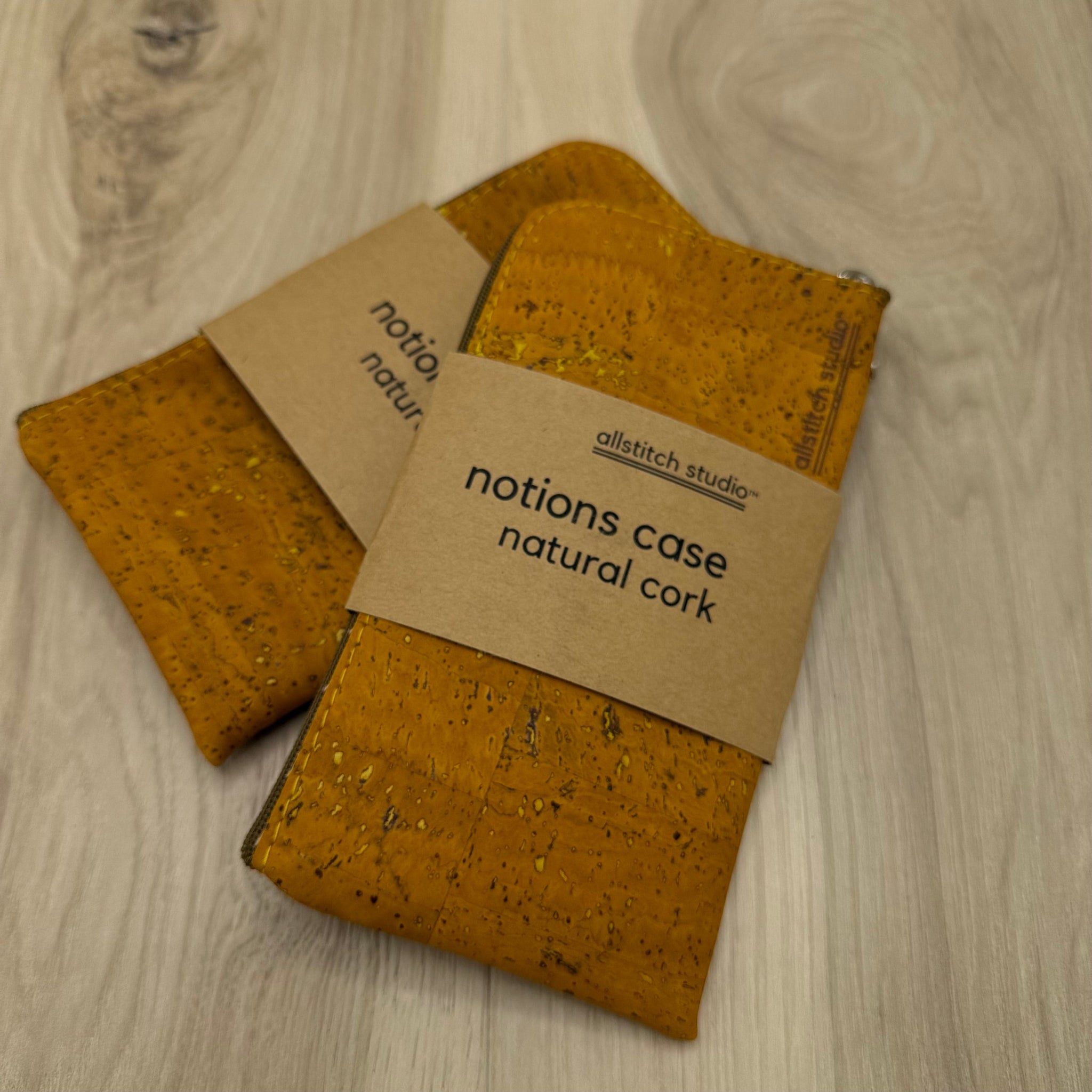 Cork notions case with a visible brand label on a wooden surface