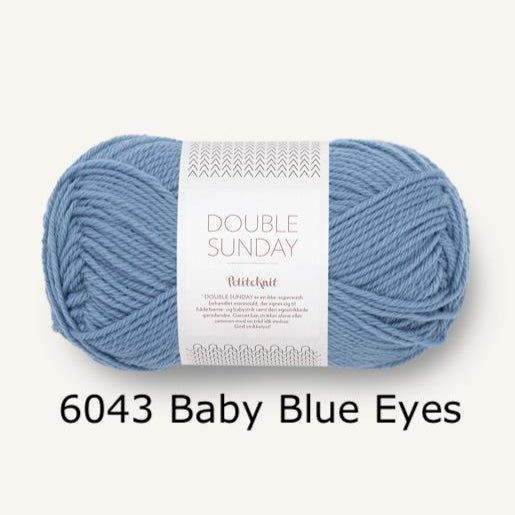 Ball of yarn with a label on a white background, labeled '6043 Baby Blue Eyes'.