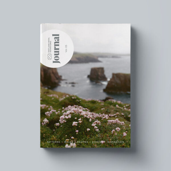 Shetland Wool Adventures Journal Volume 5 with a scenic cover featuring a coastal landscape with rocks and flowers.